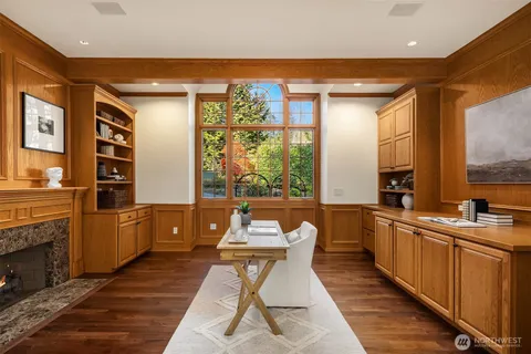 a large kitchen with stainless steel appliances a large counter top space a large window and cabinets