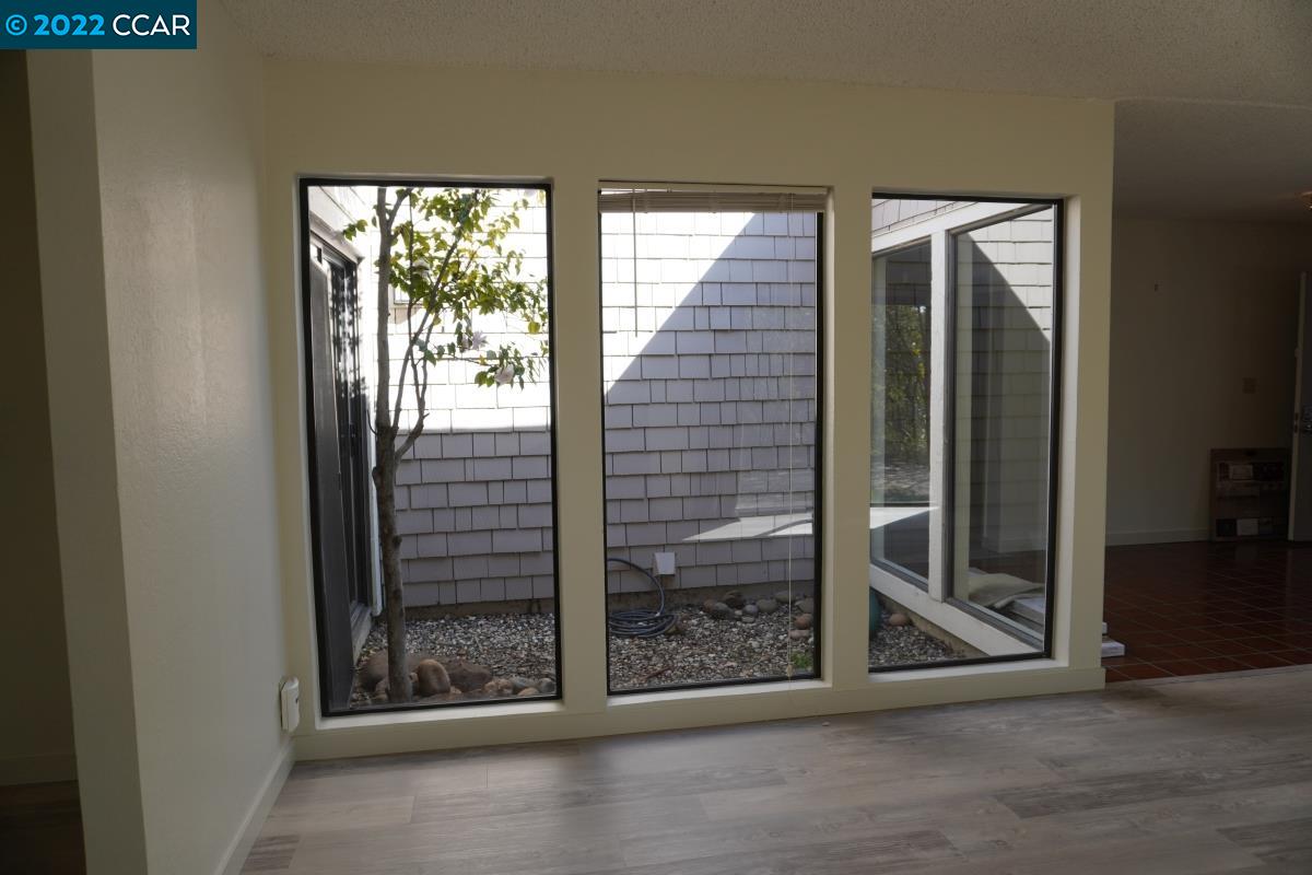 541 Adirondack Way Walnut Creek, CA 94598 - Photo 5 of 16 an empty room with wooden floor and windows