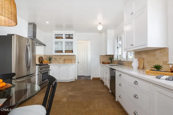 a kitchen with refrigerator and cabinets