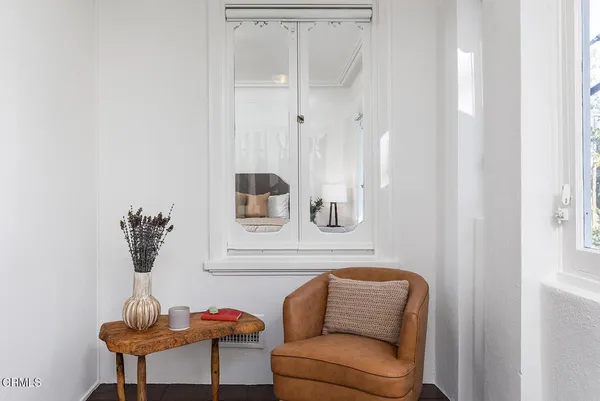 a living room with furniture and a lamp