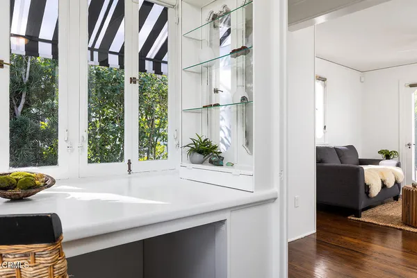 a room with a large window and wooden floor