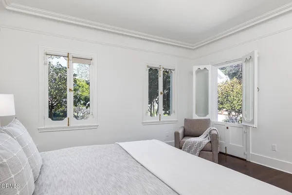 a bedroom with a large bed and a window