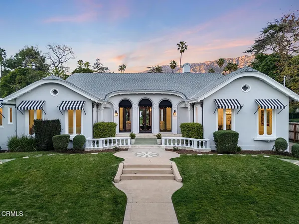 a front view of a house with a garden