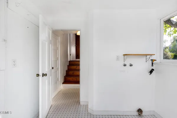 a view of a hallway with wooden shelves