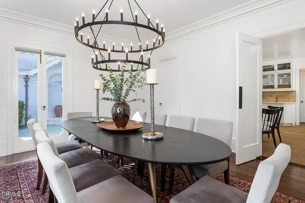 a view of a dining room with furniture and chandelier