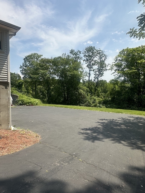 585 Burncoat Street Worcester, MA 01606 - Photo 3 of 5 a view of a yard and basketball court