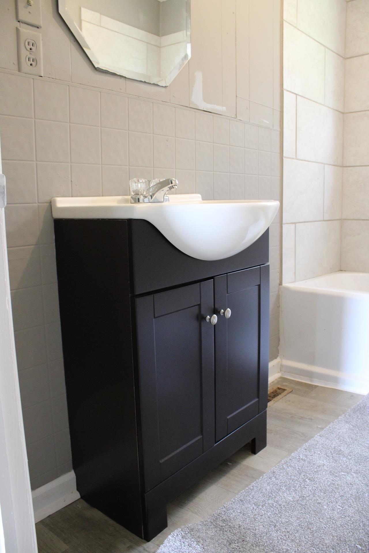 920 American Way Ripley, TN 38063 - Photo 16 of 18 a bathroom with a sink and mirror