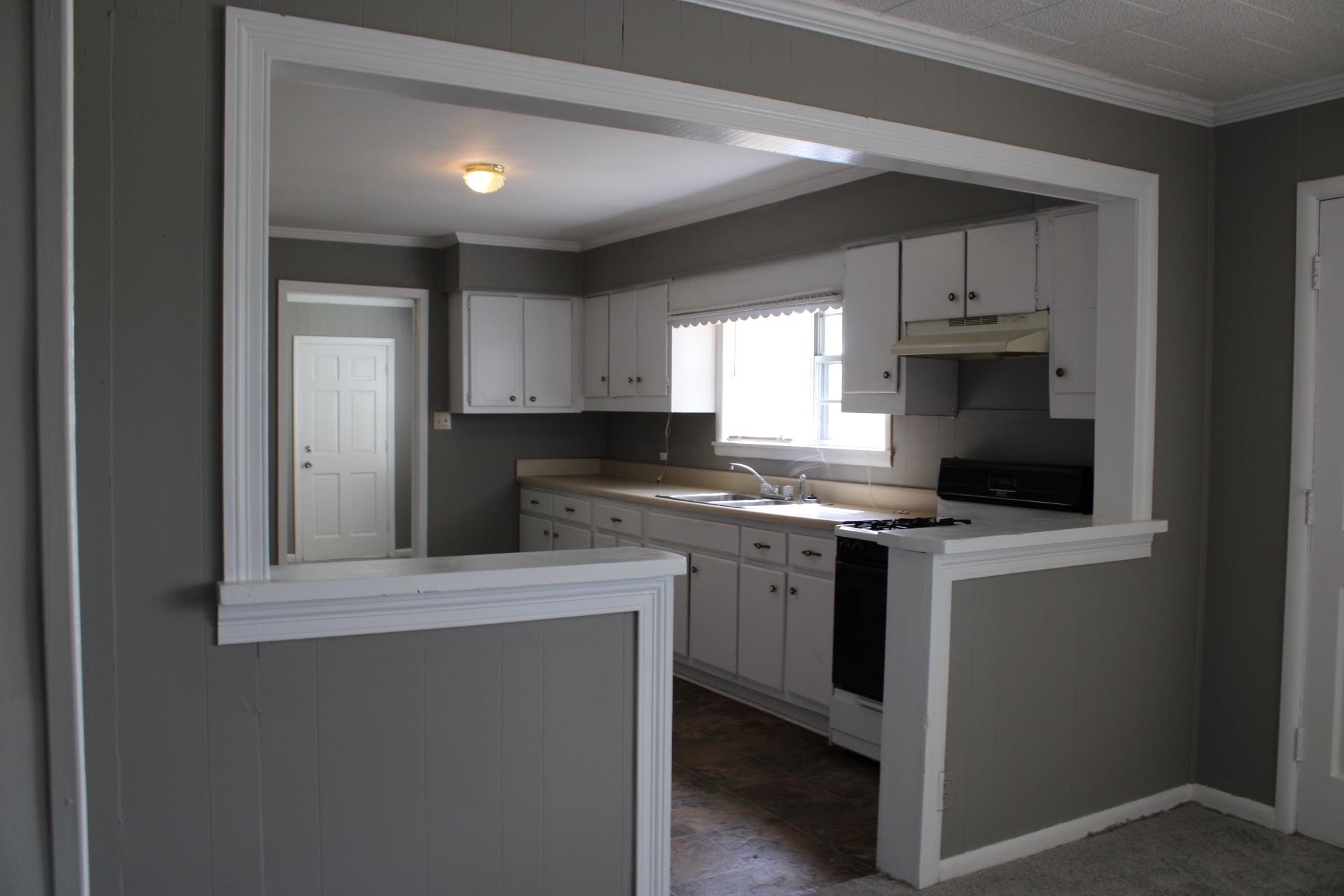 920 American Way Ripley, TN 38063 - Photo 7 of 18 a kitchen with stainless steel appliances granite countertop a stove a sink and a microwave