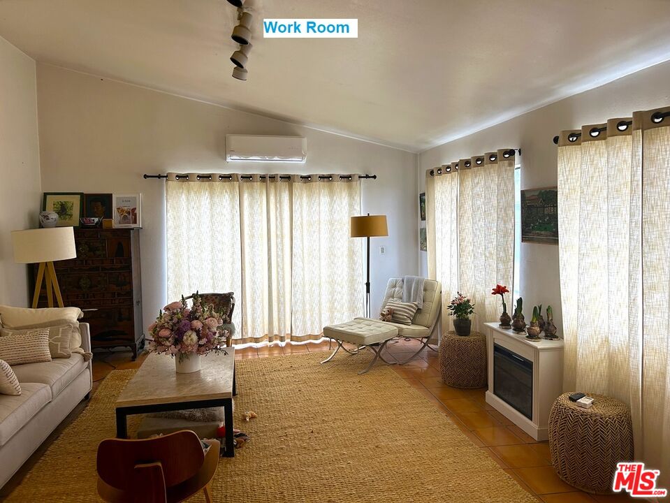 1634 Decker Canyon Malibu, CA 90265 - Photo 7 of 12 a living room with furniture and a large window