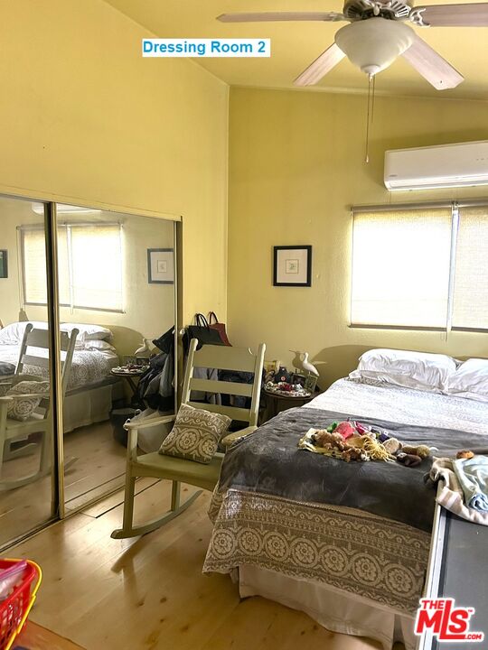 1634 Decker Canyon Malibu, CA 90265 - Photo 8 of 12 a bedroom with a bed and wooden floor