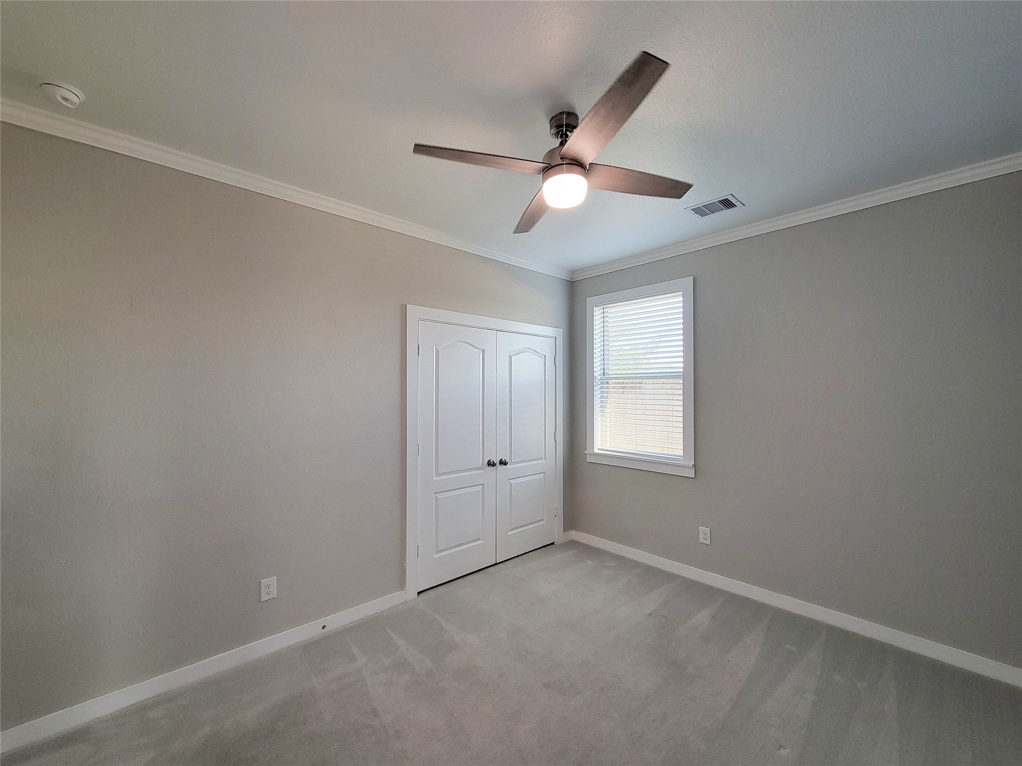 31402 Conover Drive Fulshear, TX 77441 - Photo 11 of 20 an empty room with a window and a fan