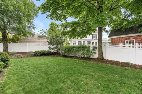 an aerial view of a house with a yard and garden