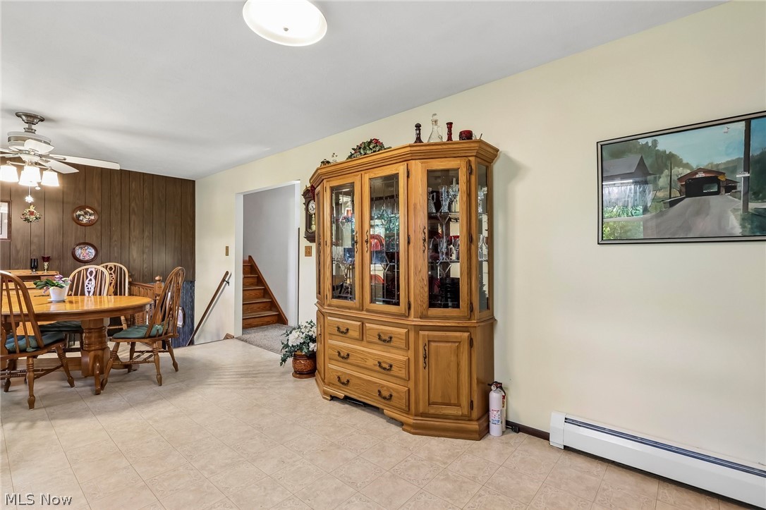2428 Antioch Road Perry, OH 44081 - Photo 25 of 46 Spacious dining area featuring neutral-toned flooring, light-colored walls, and a decorative wood-paneled accent wall