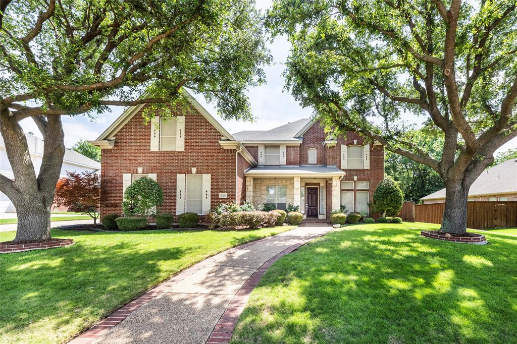 Traditional-style house featuring brick siding