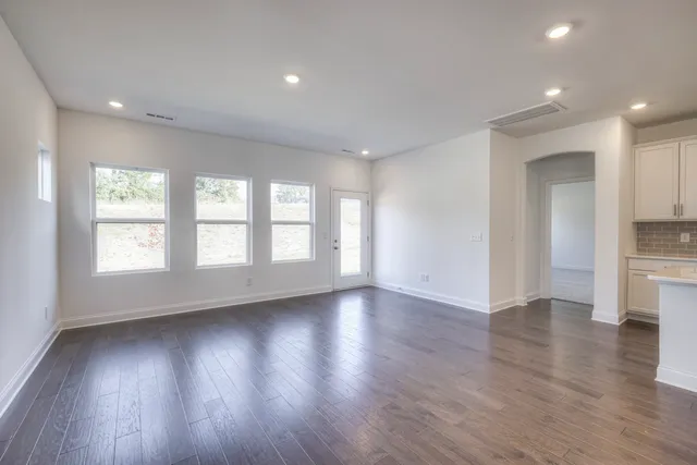 a kitchen with white cabinets appliances and sink