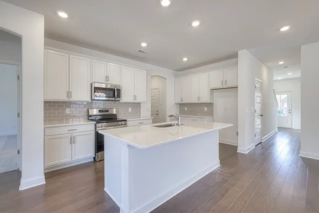 a kitchen with a sink a stove and cabinets