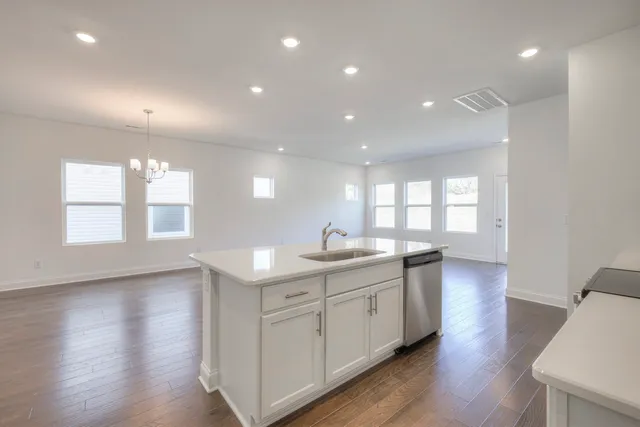 a kitchen with white cabinets and a sink