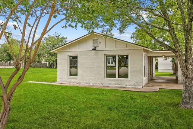 a front view of house with yard and green space