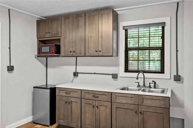 a kitchen with sink cabinets and window