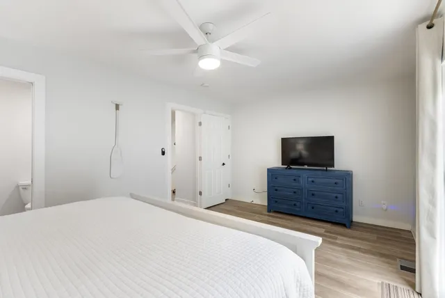 a bedroom with a bed and wooden floor