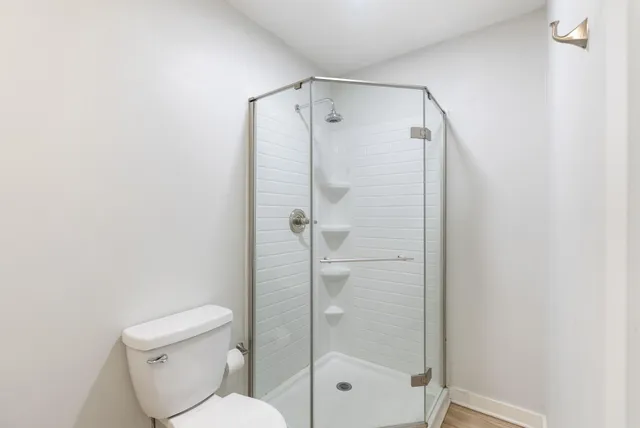 a bathroom with a toilet and shower