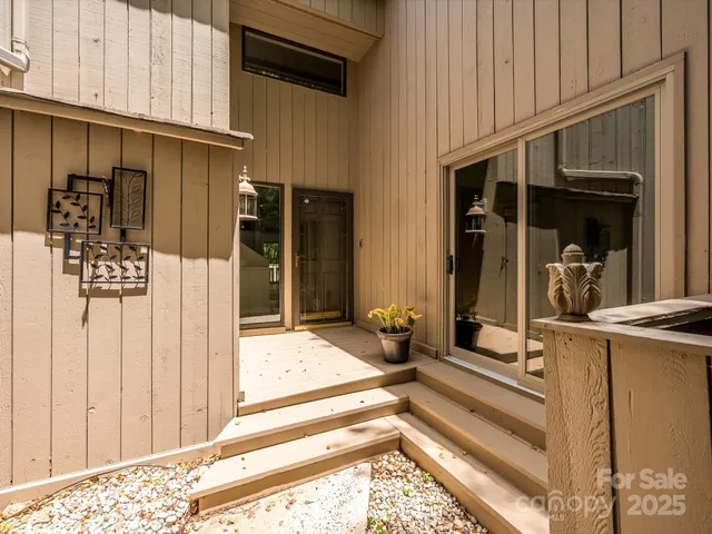a backyard of a house with lots of furniture and floor to ceiling window