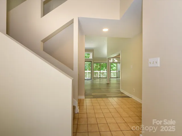 a view of empty room with wooden floor and fireplace