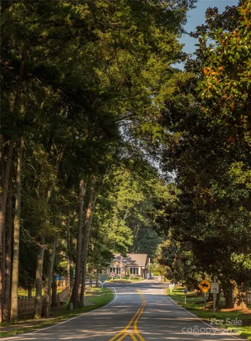a view of swimming pool with lawn chairs under an umbrella
