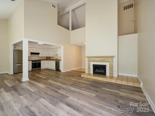 a view of a room with wooden floor and a window