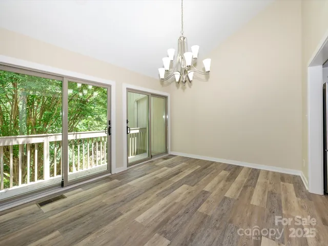 a view of a kitchen with wooden floor and a sink