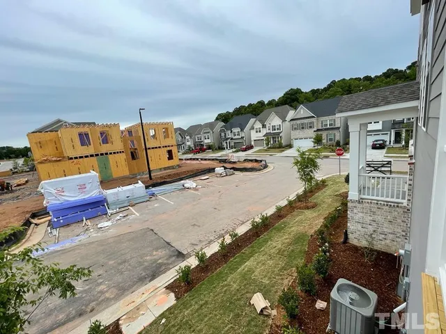 a large kitchen with a lot of counter space and wooden floor