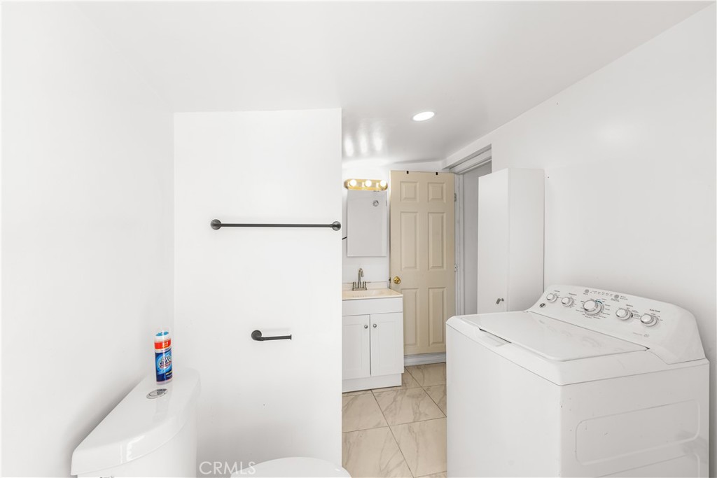 6308 Hawarden Drive Riverside, CA 92506 - Photo 30 of 37 a bathroom with a sink a toilet and shower