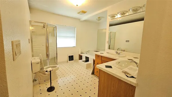 a bathroom with a sink mirror and shower