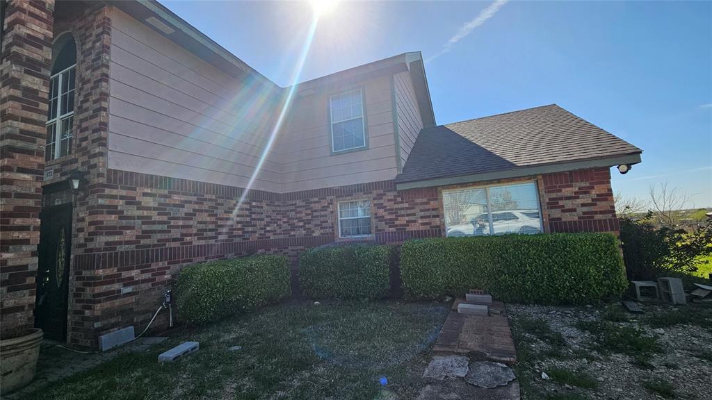 8736 Johns Road Alvarado, TX 76009 - Photo 26 of 32 a view of a house with a small yard and outdoor seating