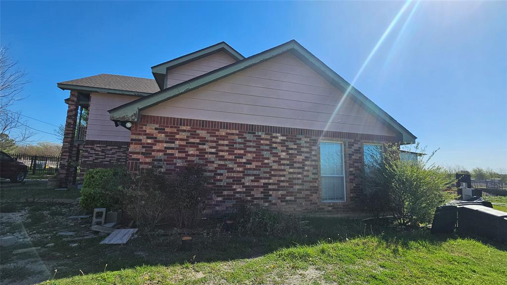 8736 Johns Road Alvarado, TX 76009 - Photo 27 of 32 a front view of a house with garden
