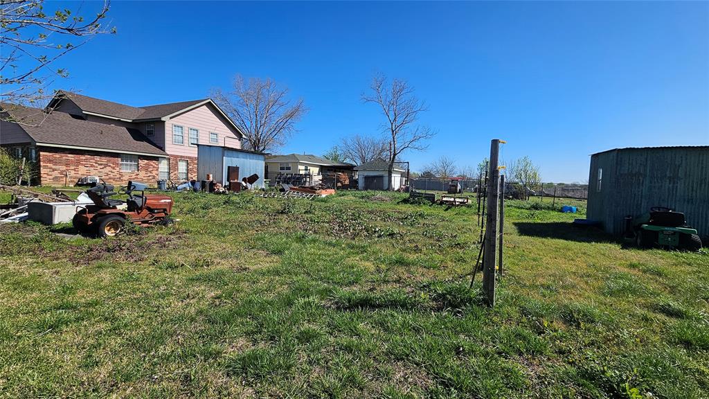 8736 Johns Road Alvarado, TX 76009 - Photo 32 of 32 a backyard of a house with a garden and outdoor seating