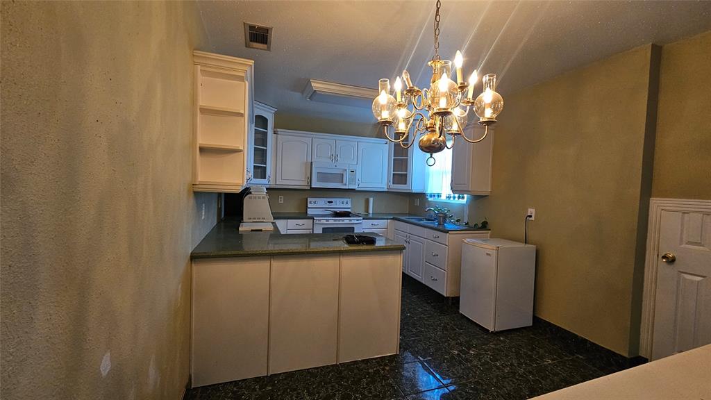 8736 Johns Road Alvarado, TX 76009 - Photo 6 of 32 a kitchen with a sink and cabinets