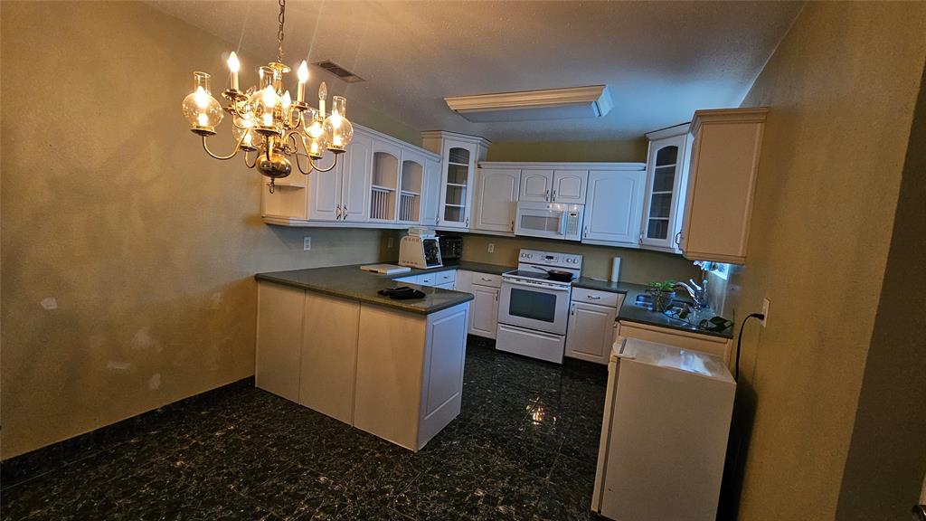 8736 Johns Road Alvarado, TX 76009 - Photo 7 of 32 a kitchen with stainless steel appliances granite countertop a sink a stove a refrigerator a counter top space and cabinets