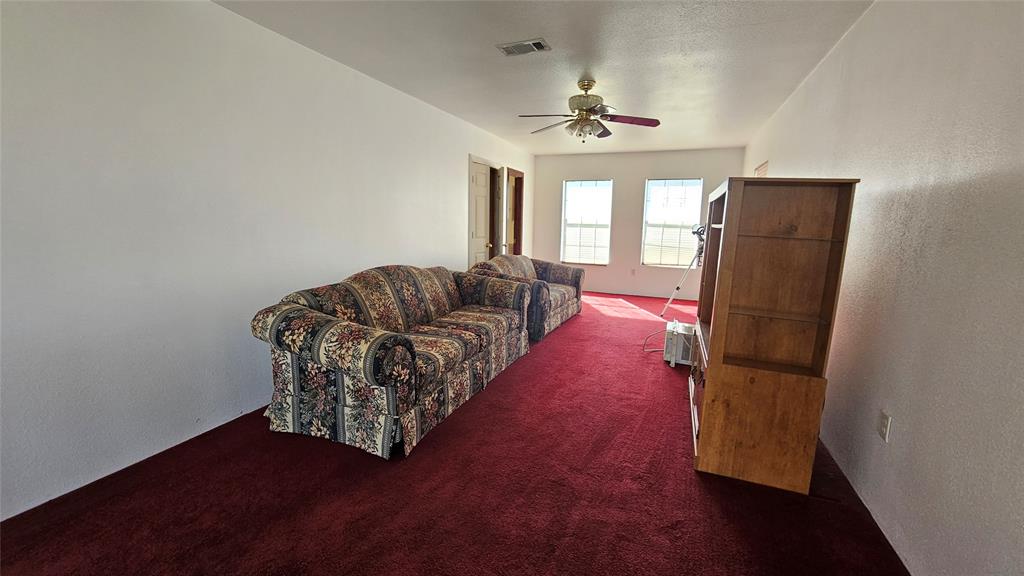 8736 Johns Road Alvarado, TX 76009 - Photo 9 of 32 a living room with furniture and a floor to ceiling window