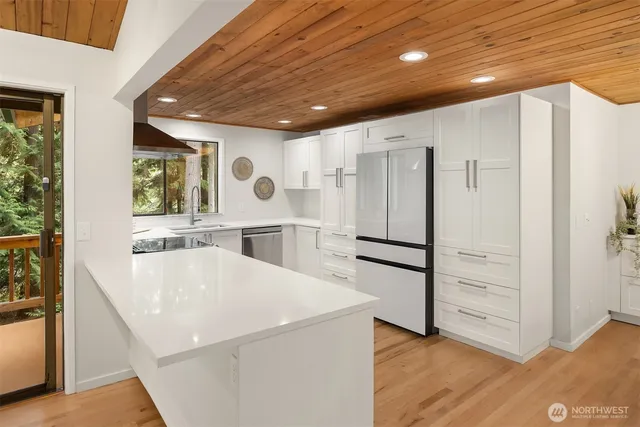 a large living room with stainless steel appliances granite countertop furniture and a large window