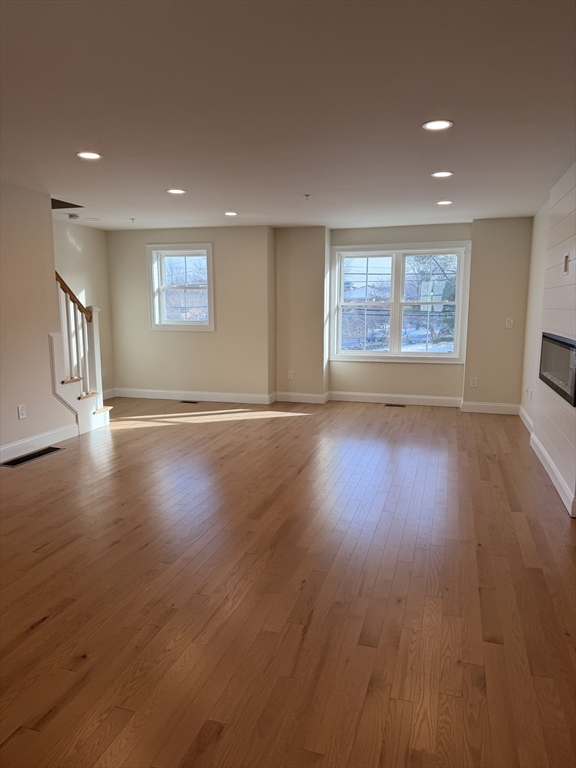 9 Acton Road, Unit 8 Chelmsford, MA 01824 - Photo 12 of 12 an empty room with wooden floor and windows
