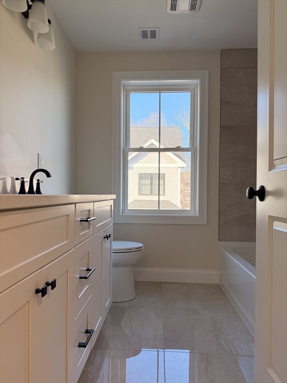 9 Acton Road, Unit 8 Chelmsford, MA 01824 - Photo 9 of 12 a bathroom with a sink toilet and tub