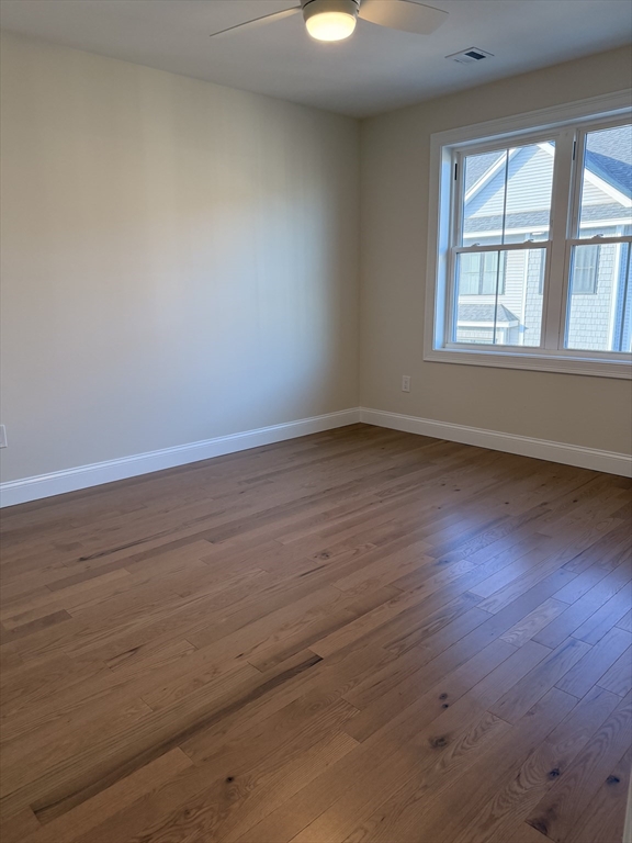 9 Acton Road, Unit 8 Chelmsford, MA 01824 - Photo 10 of 12 a view of an empty room with wooden floor and a window
