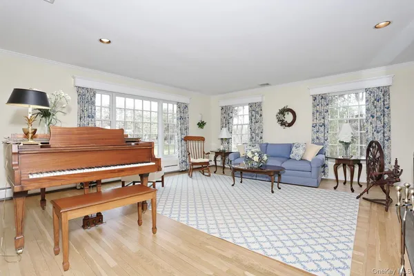 a living room with furniture a rug and a window