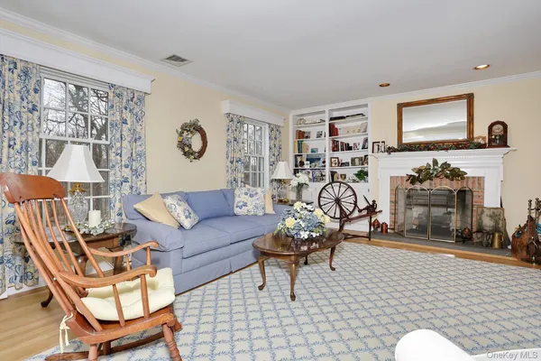 a living room with furniture a rug and a flat screen tv