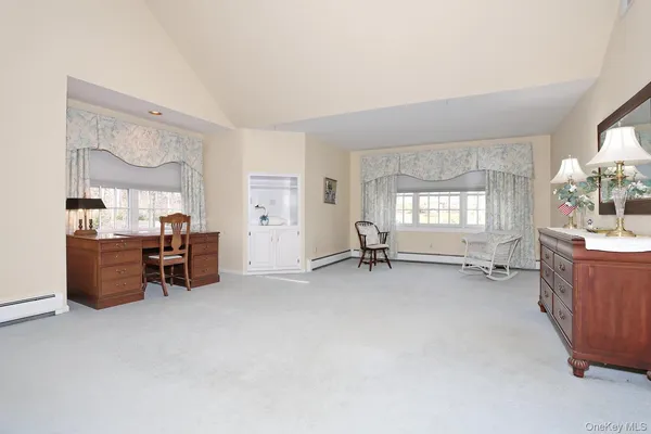 a room with a bed and a dresser in it
