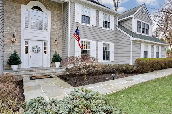 a front view of a house with a garden