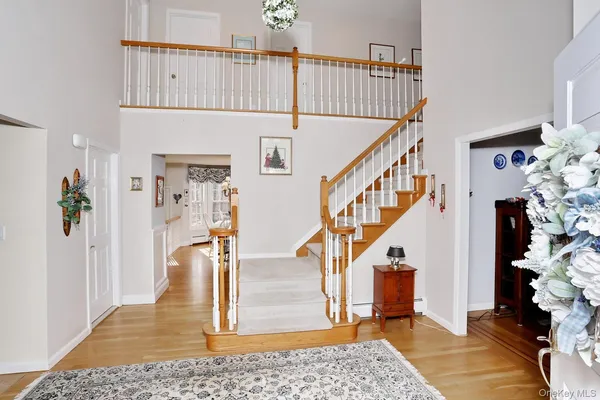 a view of entryway and hall with wooden floor