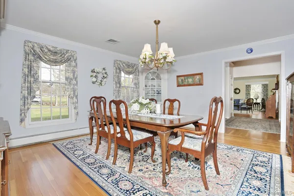 a dining room with furniture a rug and wooden floor