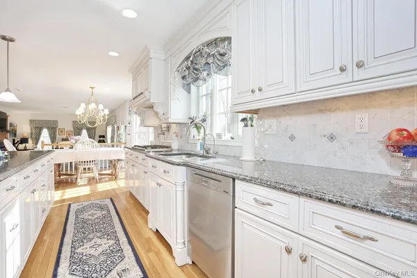 a open kitchen with granite countertop a sink stainless steel appliances and cabinets